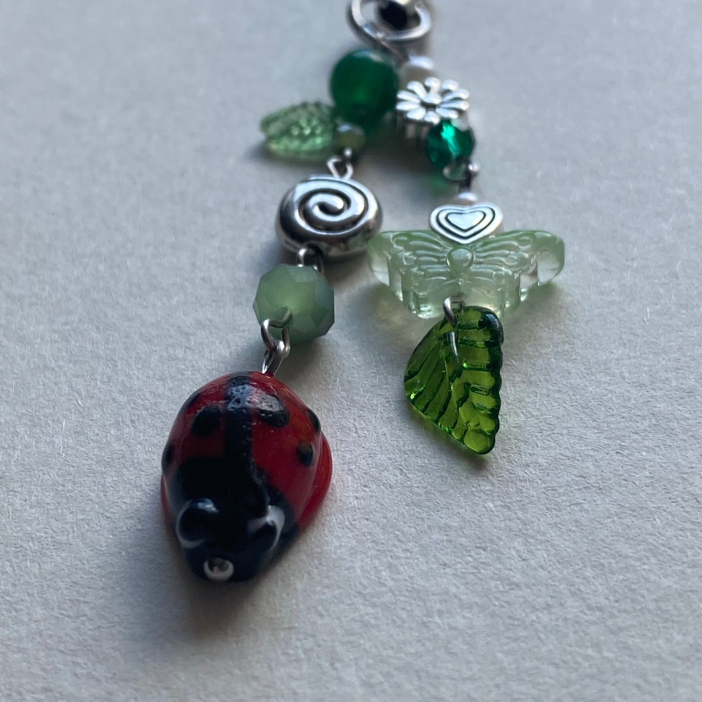 ladybug swirl phone charm
